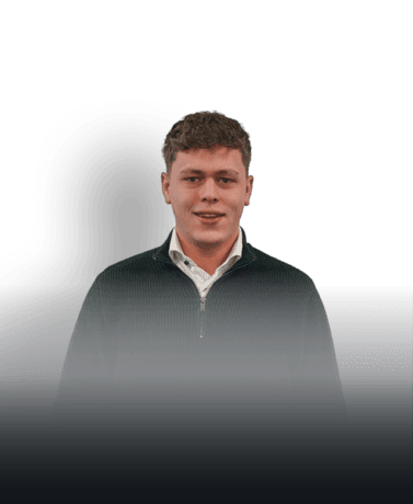 Portret van jonge man met korte, krullende haar en donkere trui.